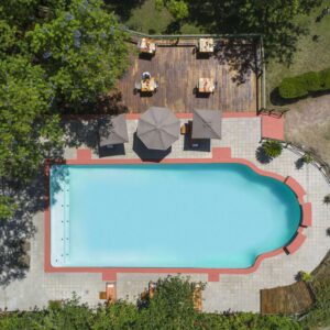 Aerial view of the swimming pool, loungers and lawns at Sedia Hotel in Maun, Botswana