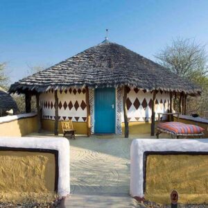 A thatched Bakalanga-style hut with painted ochre and white walls at Planet Baobab, Gweta, Botswana