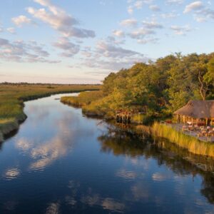 Aerial view of Camp Xakanaxa beside the Khwai channel and the Moremi floodplains, Okavango Delta, Botswana