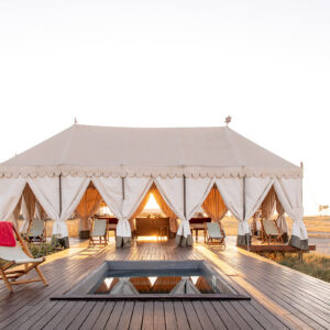The white canvas pool pavilion and lap pool of San Camp on the edge of Nwetwe Pan, Makgadikgadi, Botswana