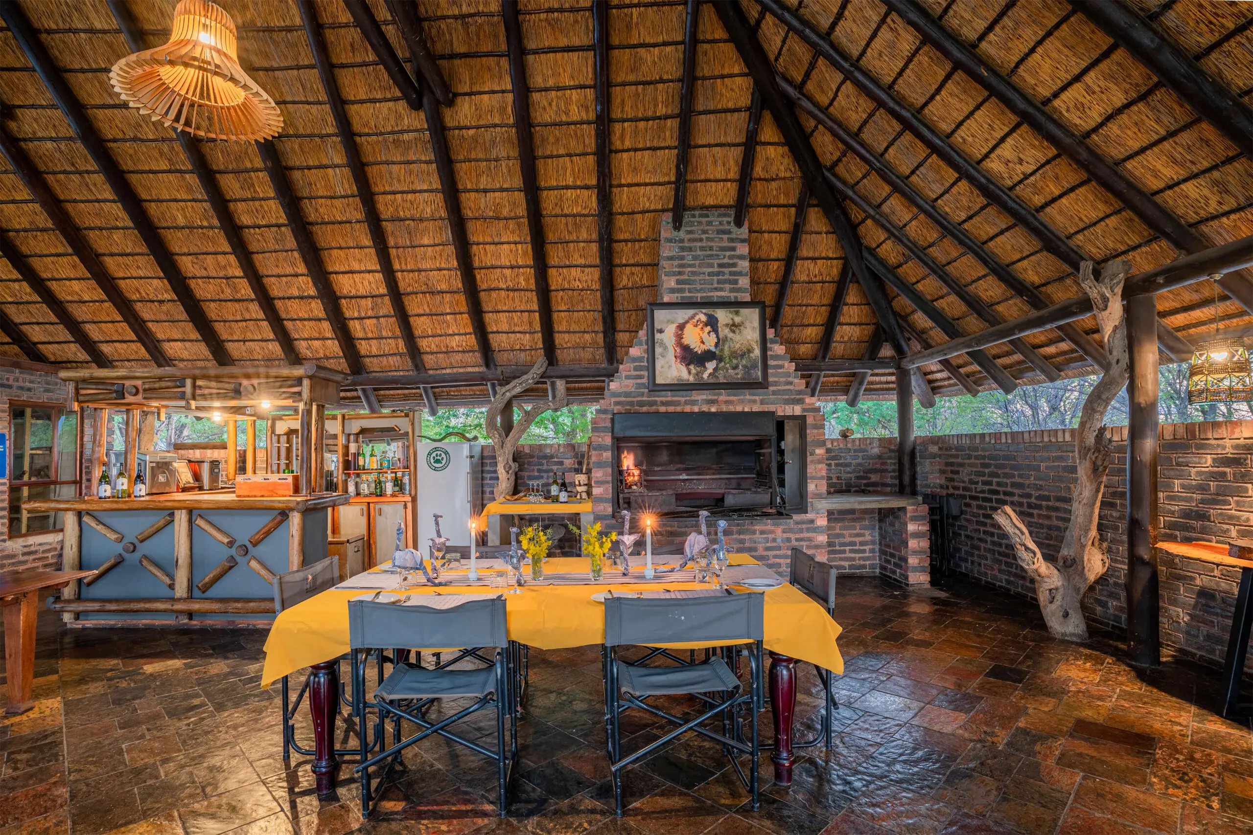The bar and open fireplace under thatch in the main area at Grassland Safari Lodge, Kalahari, Botswana