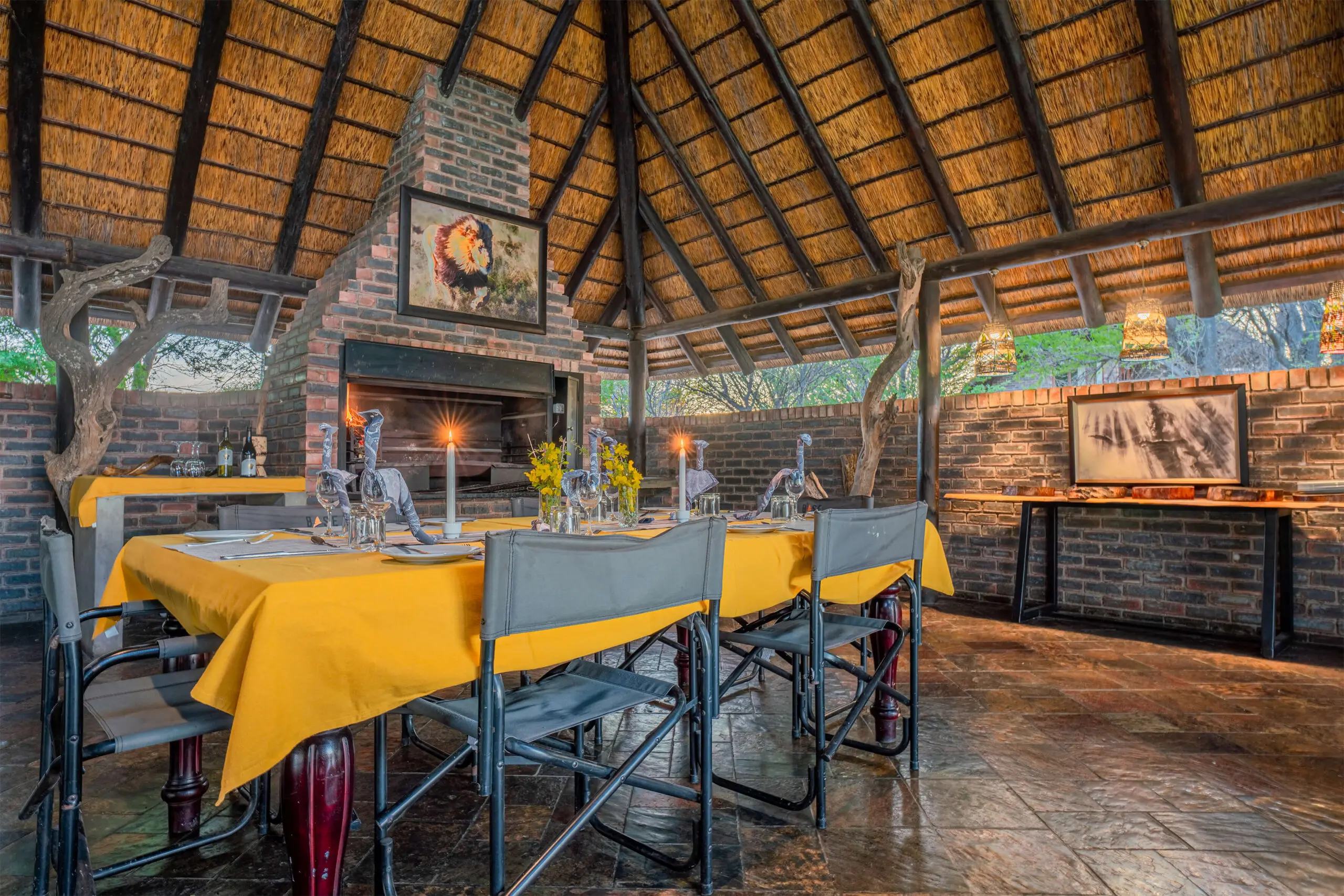 The communal dining table laid under thatch at Grassland Safari Lodge, Kalahari, Botswana