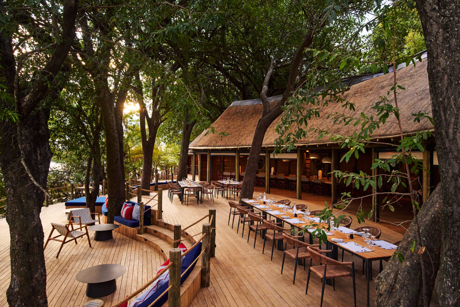 The thatched main area and multi-level timber decks of Xugana Island Lodge above Xugana Lagoon, Okavango Delta, Botswana