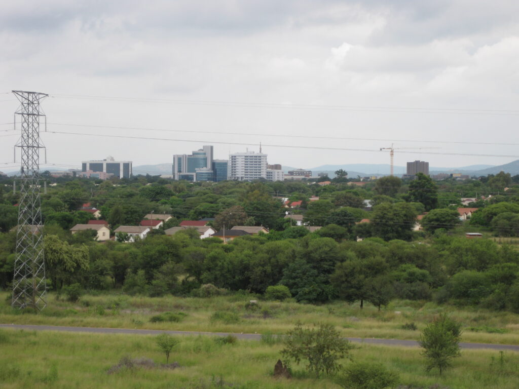 The skyline of Gaborone across low bush, the city Cresta Lodge Gaborone stands in