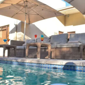 The swimming pool and shaded poolside seating at Cresta Maun, Maun, Botswana