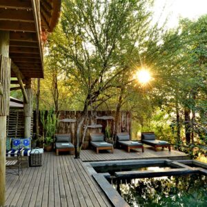 The timber pool deck, plunge pool and shaded seating under thatch at Chobe Bakwena Lodge on the Chobe River, Botswana